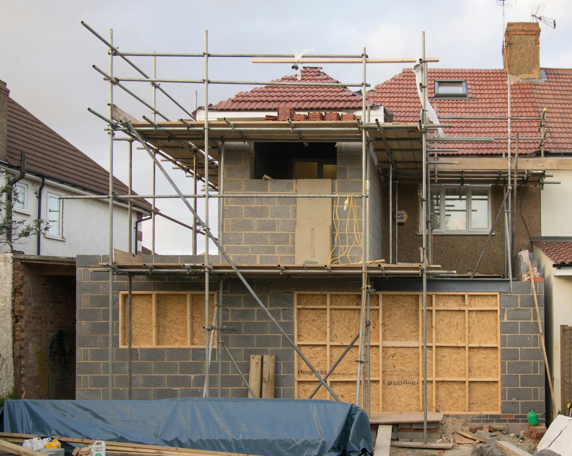 A house extension under construction surrounded by scaffolding.