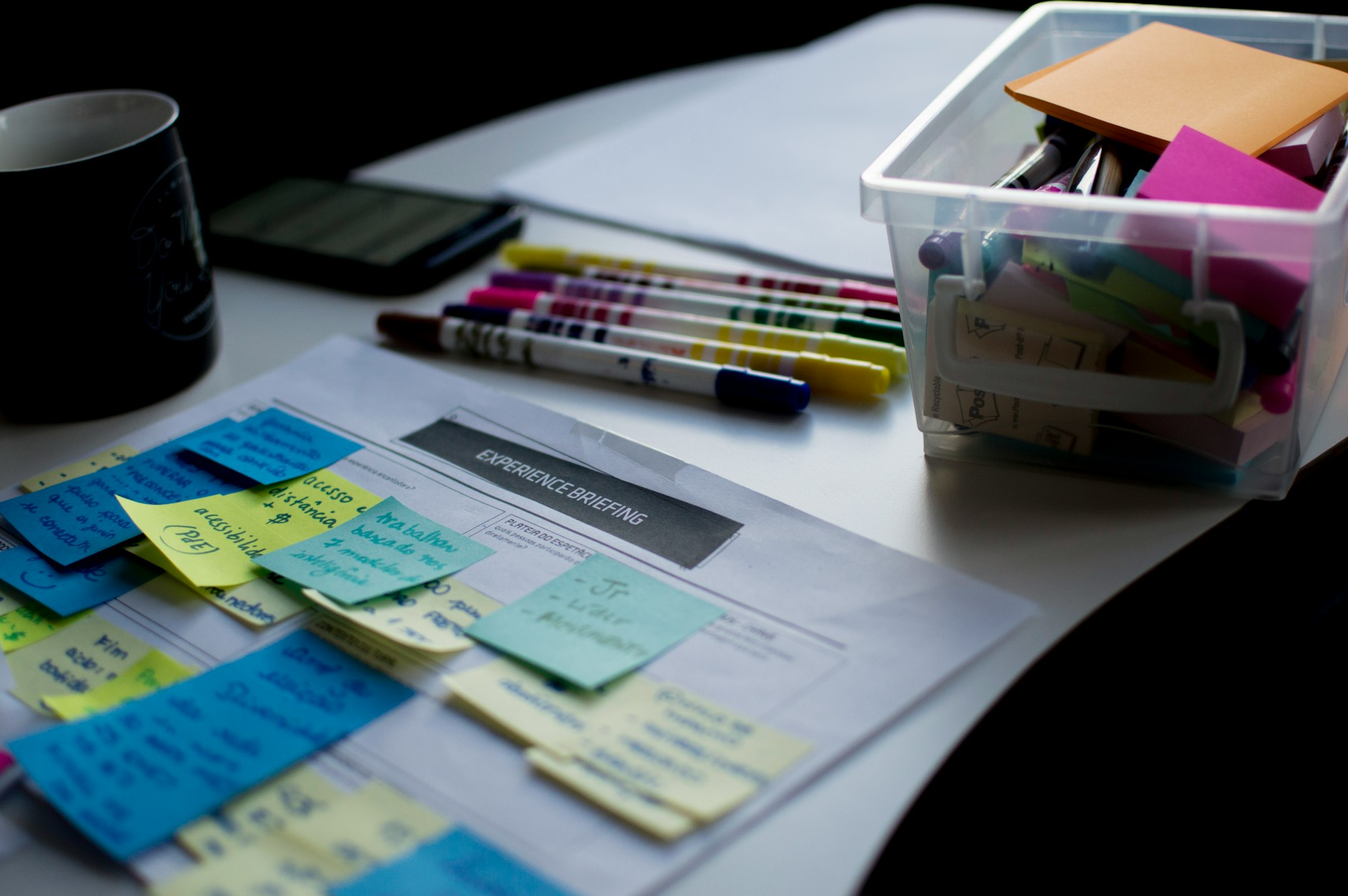 Planning notes and coloured pens spread across a desk.